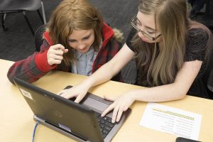 Two girls working on a computer