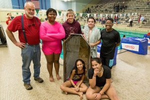 Students standing with their cardboard boat