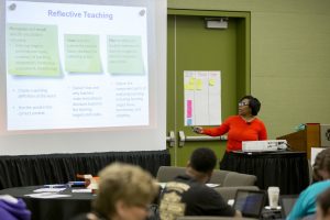 Speaker presenting to a room full of teachers