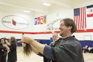 Teacher holding locks of hair.