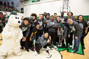 Basketball team posing after a pep rally.