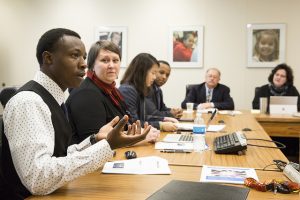 Student presenting at a conference table.