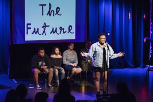 Student reading poetry on stage