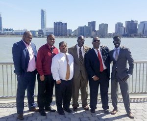 Six Brother to Brother instructors pose in front of Detriot skyline.