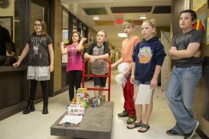 Students pushing cart with food