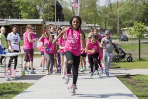 Girl, in pink, runs on new trail.